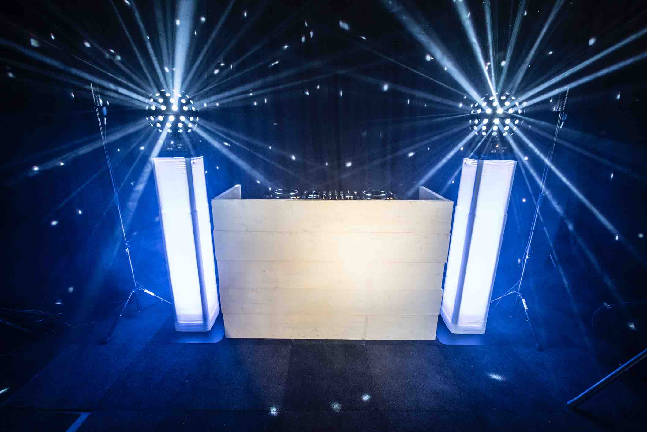 DJ show with white scaffolding wooden DJ booth