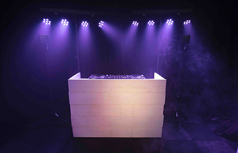  Hire a DJ with white scaffolding wooden DJ booth.